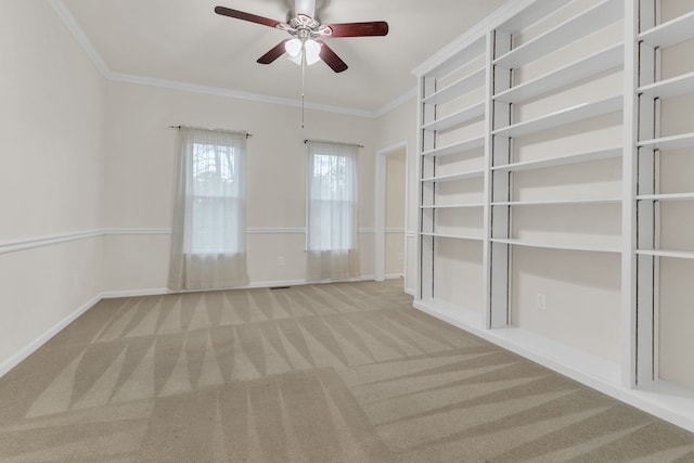 empty room featuring carpet flooring, ceiling fan, and ornamental molding