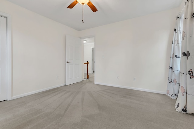 carpeted empty room with ceiling fan