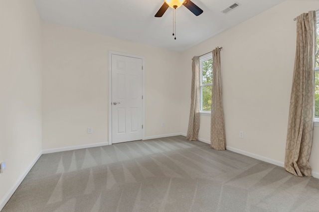 spare room featuring ceiling fan and light carpet