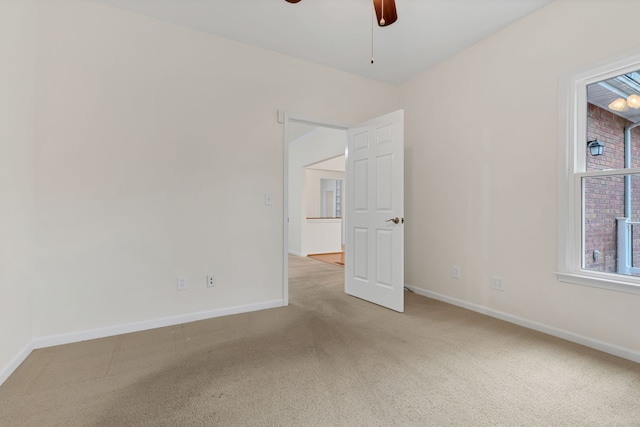 carpeted empty room featuring ceiling fan