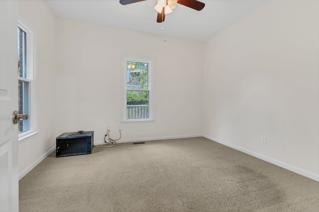 empty room with ceiling fan and carpet