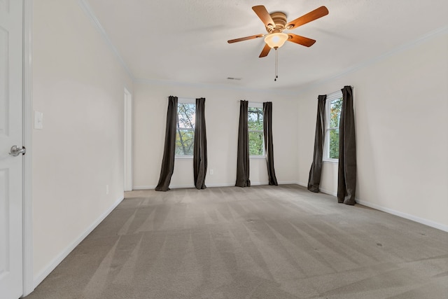 unfurnished room with ceiling fan, ornamental molding, and light carpet