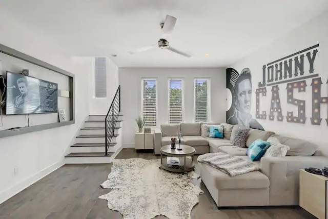 living room featuring ceiling fan and dark hardwood / wood-style floors