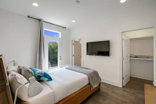 bedroom with dark wood-type flooring and access to outside