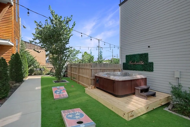 view of yard featuring a hot tub and a deck