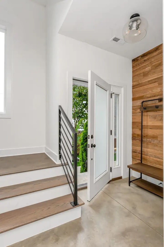 entrance foyer featuring wooden walls