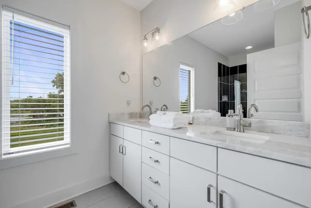 bathroom with vanity, tile patterned flooring, and plenty of natural light