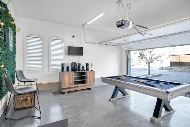 recreation room featuring concrete flooring, a healthy amount of sunlight, and billiards