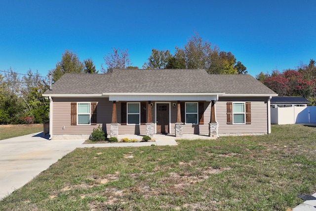 view of front of house with a porch, a front lawn, and a storage unit