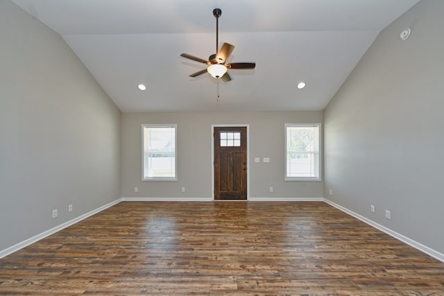 entryway featuring dark hardwood / wood-style flooring, a healthy amount of sunlight, and vaulted ceiling