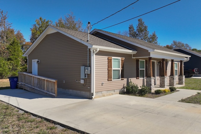 view of side of home with covered porch