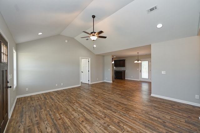 unfurnished living room with dark wood-type flooring, lofted ceiling, and ceiling fan with notable chandelier