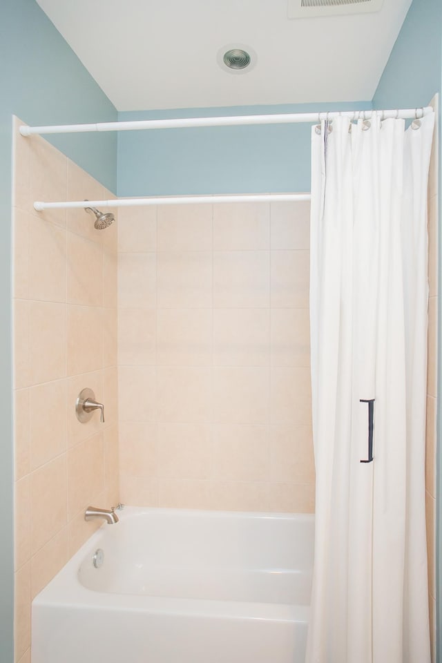 bathroom with shower / bathtub combination with curtain