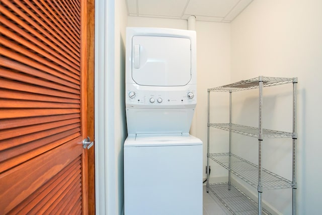 washroom with tile patterned floors and stacked washer / dryer