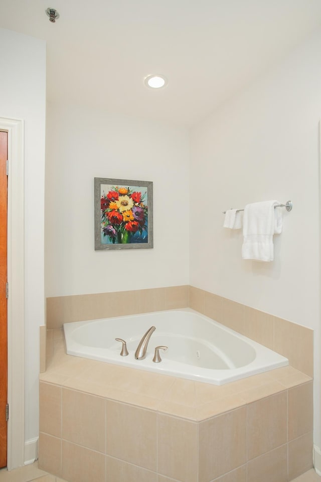 bathroom featuring tiled tub