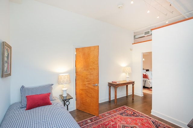 bedroom with dark wood-type flooring