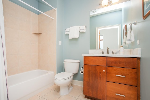 full bathroom featuring toilet, vanity, tiled shower / bath combo, and tile patterned floors