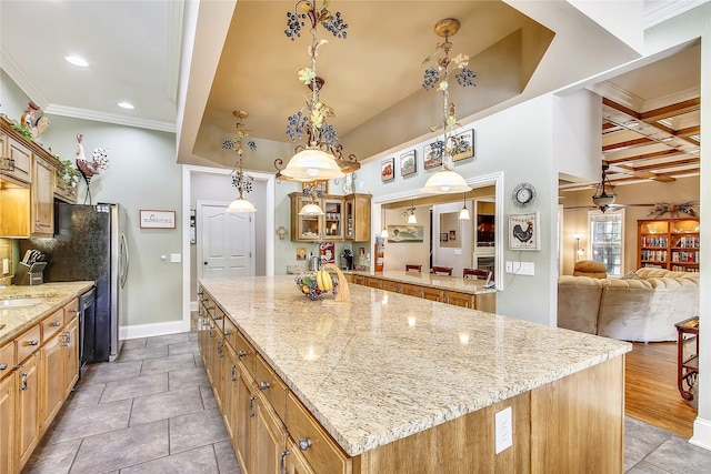 kitchen with wood-type flooring, ornamental molding, a kitchen island, beam ceiling, and coffered ceiling