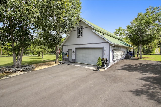 view of home's exterior featuring a lawn and a garage