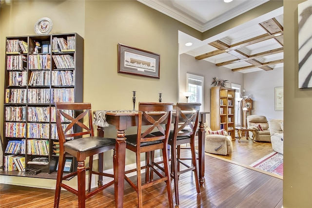 dining area featuring hardwood / wood-style floors, beam ceiling, crown molding, and coffered ceiling