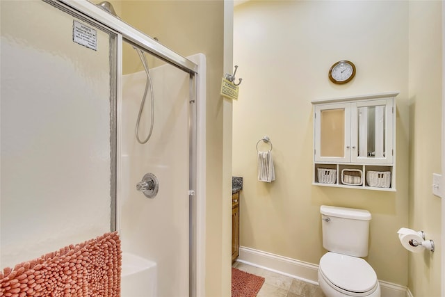 bathroom featuring walk in shower, vanity, toilet, and tile patterned flooring