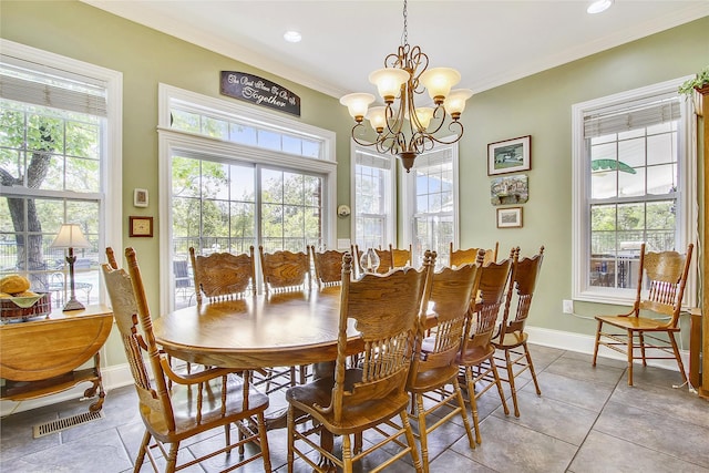 dining space with a chandelier, a wealth of natural light, light tile patterned floors, and ornamental molding