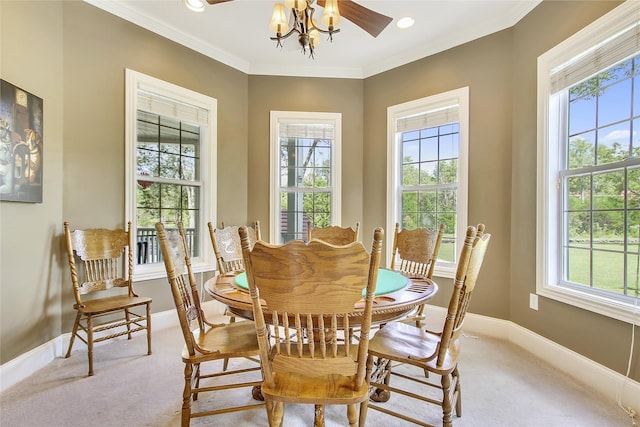 dining room with a wealth of natural light, light carpet, and crown molding