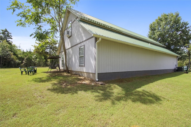 view of property exterior with central AC unit, cooling unit, and a yard