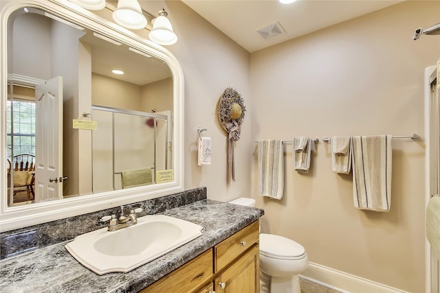 bathroom featuring walk in shower, tile patterned floors, vanity, and toilet