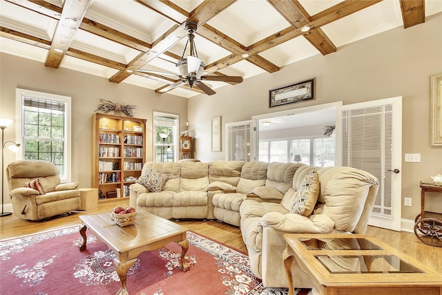 living room with light wood-type flooring, beamed ceiling, ceiling fan, and coffered ceiling