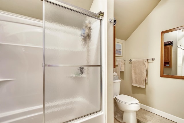 bathroom with tile patterned flooring, combined bath / shower with glass door, vaulted ceiling, and toilet