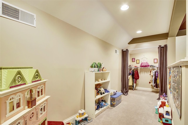 rec room featuring light colored carpet and lofted ceiling