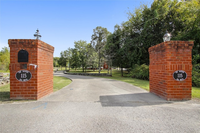 view of gate featuring a yard