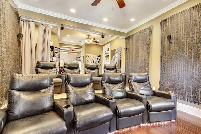 home theater room with ornamental molding, hardwood / wood-style floors, and ceiling fan