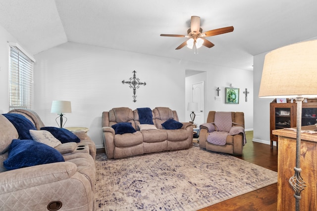 living room featuring dark hardwood / wood-style flooring, ceiling fan, and lofted ceiling