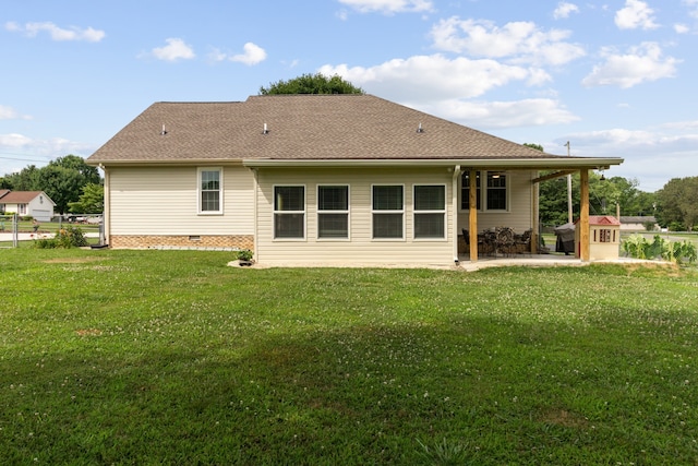 rear view of house featuring a yard and a patio area