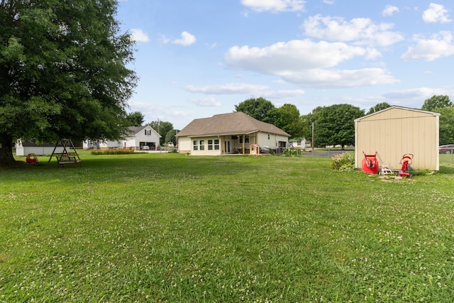 view of yard featuring a playground and a storage shed