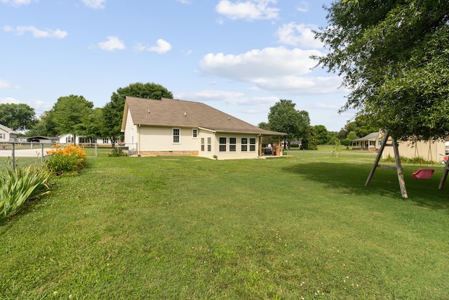 back of property featuring a yard