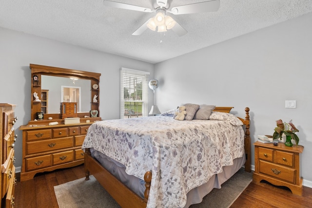 bedroom with ceiling fan, a textured ceiling, and dark hardwood / wood-style floors