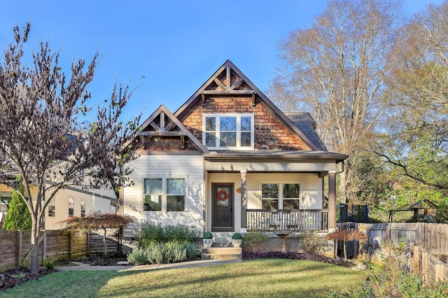 craftsman house with covered porch and a front yard