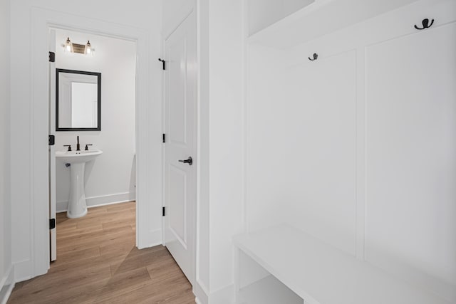 mudroom with light hardwood / wood-style floors