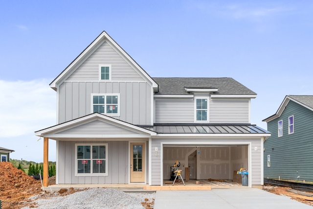 modern inspired farmhouse with a garage and a porch