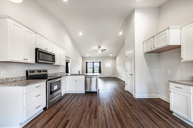 kitchen with kitchen peninsula, sink, dark hardwood / wood-style floors, white cabinetry, and appliances with stainless steel finishes