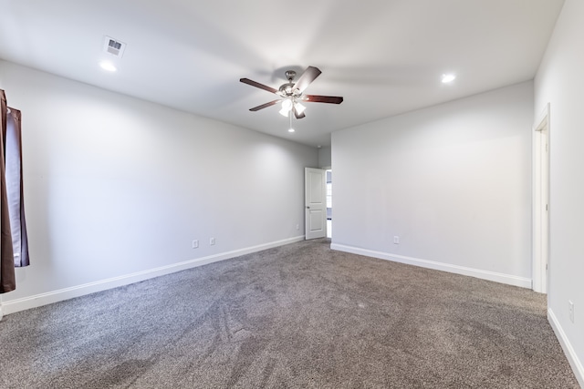 carpeted spare room featuring ceiling fan