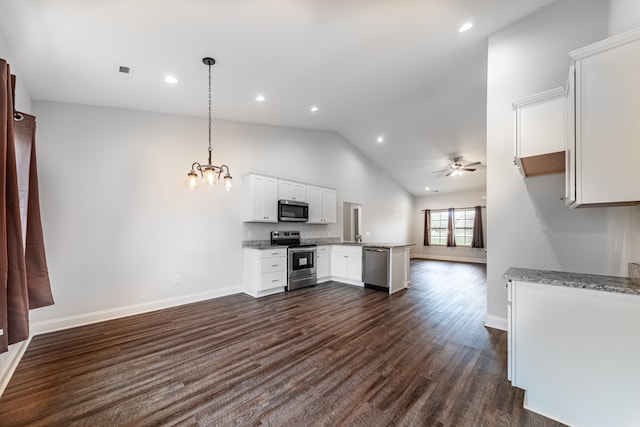 kitchen with stainless steel appliances, decorative light fixtures, white cabinets, lofted ceiling, and ceiling fan with notable chandelier