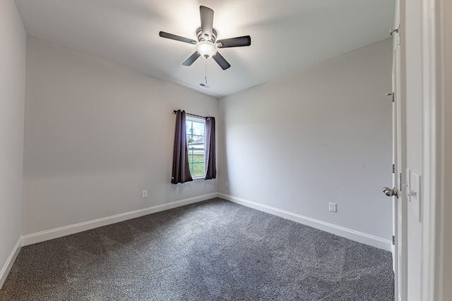 empty room featuring dark colored carpet and ceiling fan