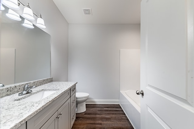 full bathroom with hardwood / wood-style floors, vanity, shower / tub combination, and toilet