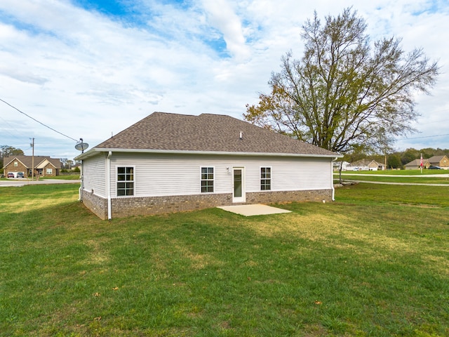 back of house featuring a patio and a lawn