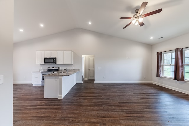 kitchen featuring dark wood-type flooring, white cabinetry, kitchen peninsula, and appliances with stainless steel finishes