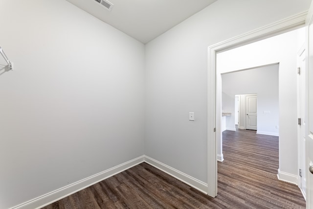 empty room with dark hardwood / wood-style flooring